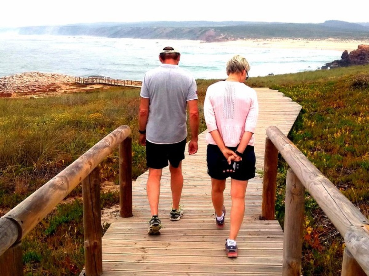 a man standing next to a body of water